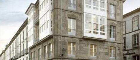 A historic building with multiple stories, large windows, and a classic architectural style.