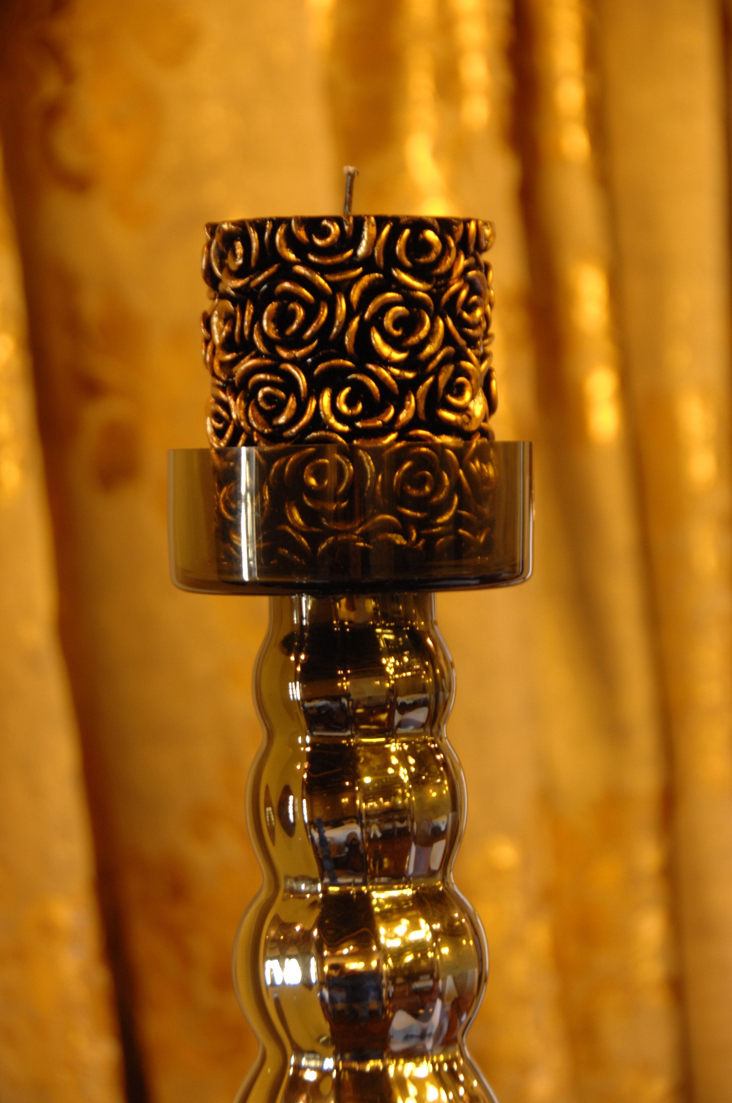 A candle holder with a floral pattern.