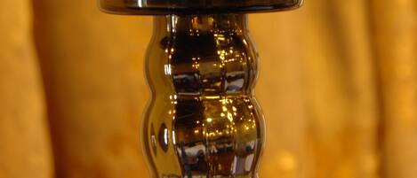 A candle holder with a floral pattern.