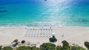 An aerial view of a beach with rows of sun loungers and a lifeguard tower. - Baglioni Resort Sardinia - The Leading Hotels of the World (San Teodoro)