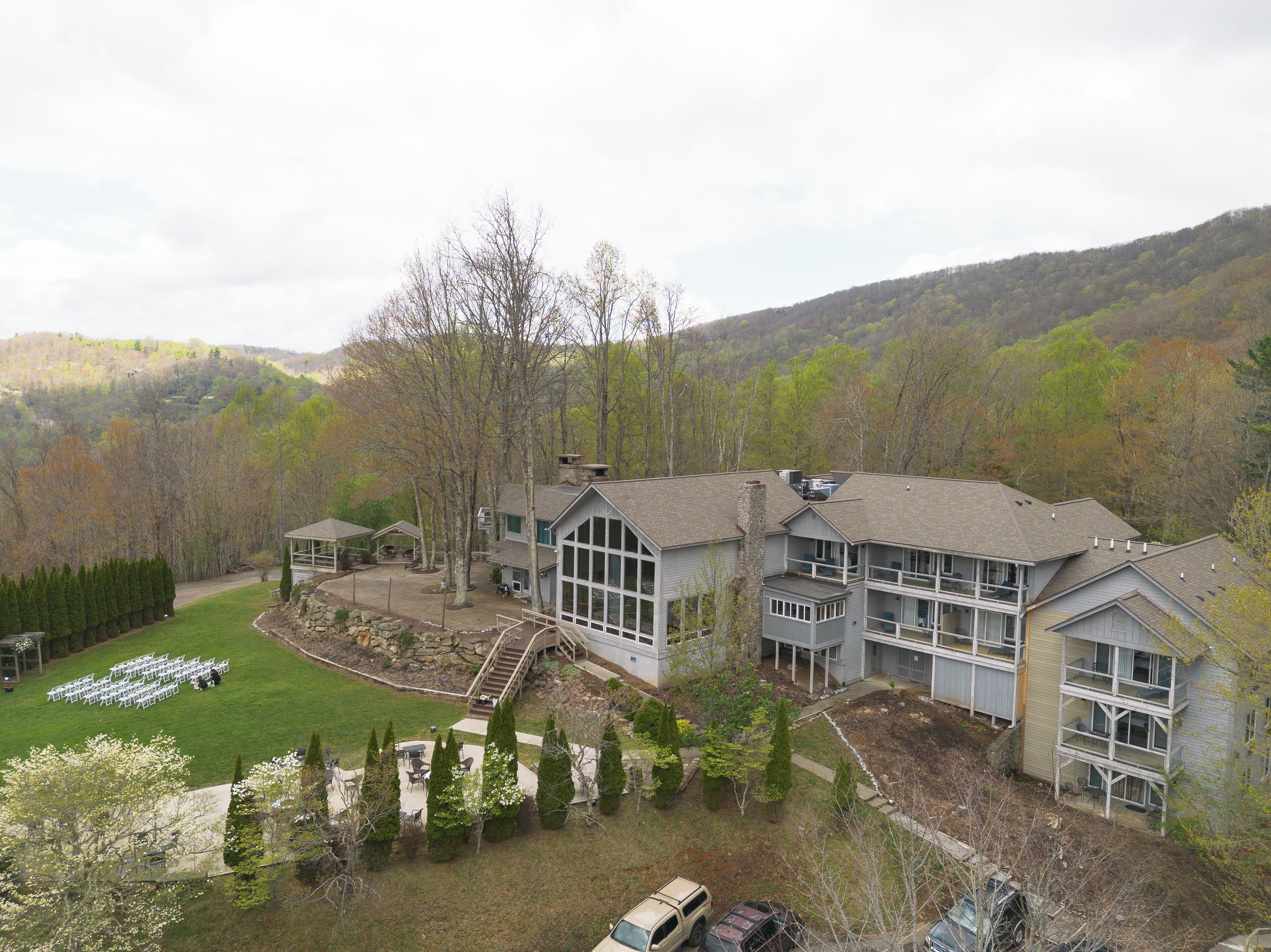 A large, multi-story building with a spacious lawn and a covered patio area.