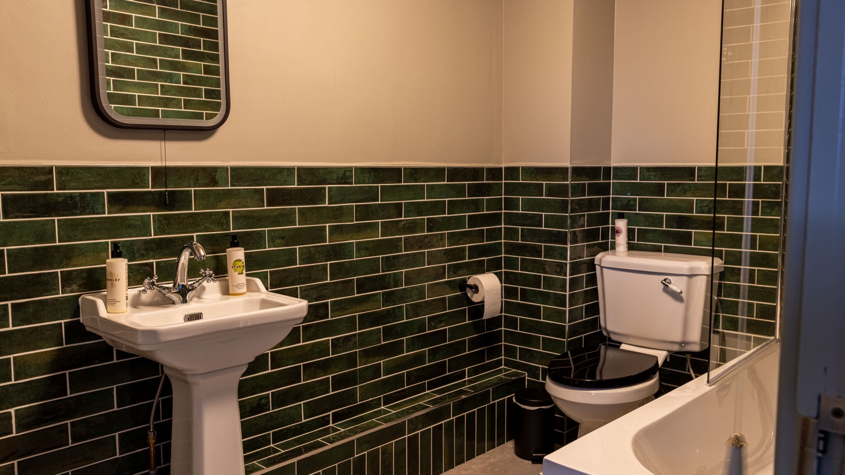 A bathroom with a white sink, a toilet, and a bathtub.