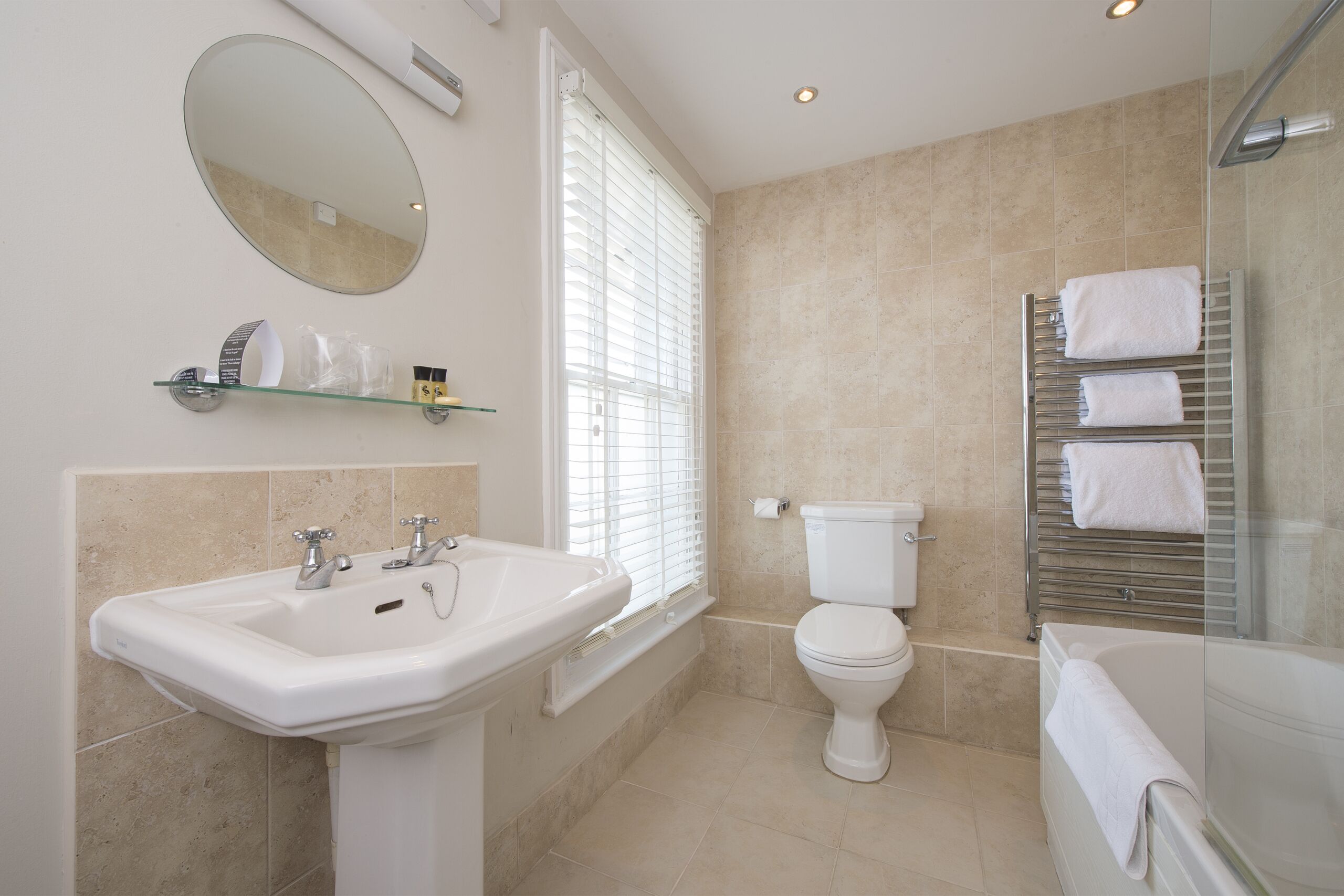 A modern bathroom with a sink, toilet, and bathtub.