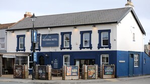The Victoria Hotel with a signboard, multiple windows, and a street view. - The Victoria Hotel (Burnham-on-Sea)