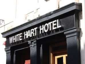 The exterior of the White Hart Hotel with a prominent sign displaying its name. - White Hart Hotel (Dumfries)