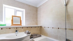 A bathroom with a sink, mirror, and shower. - Afon Duad Inn (Carmarthen)