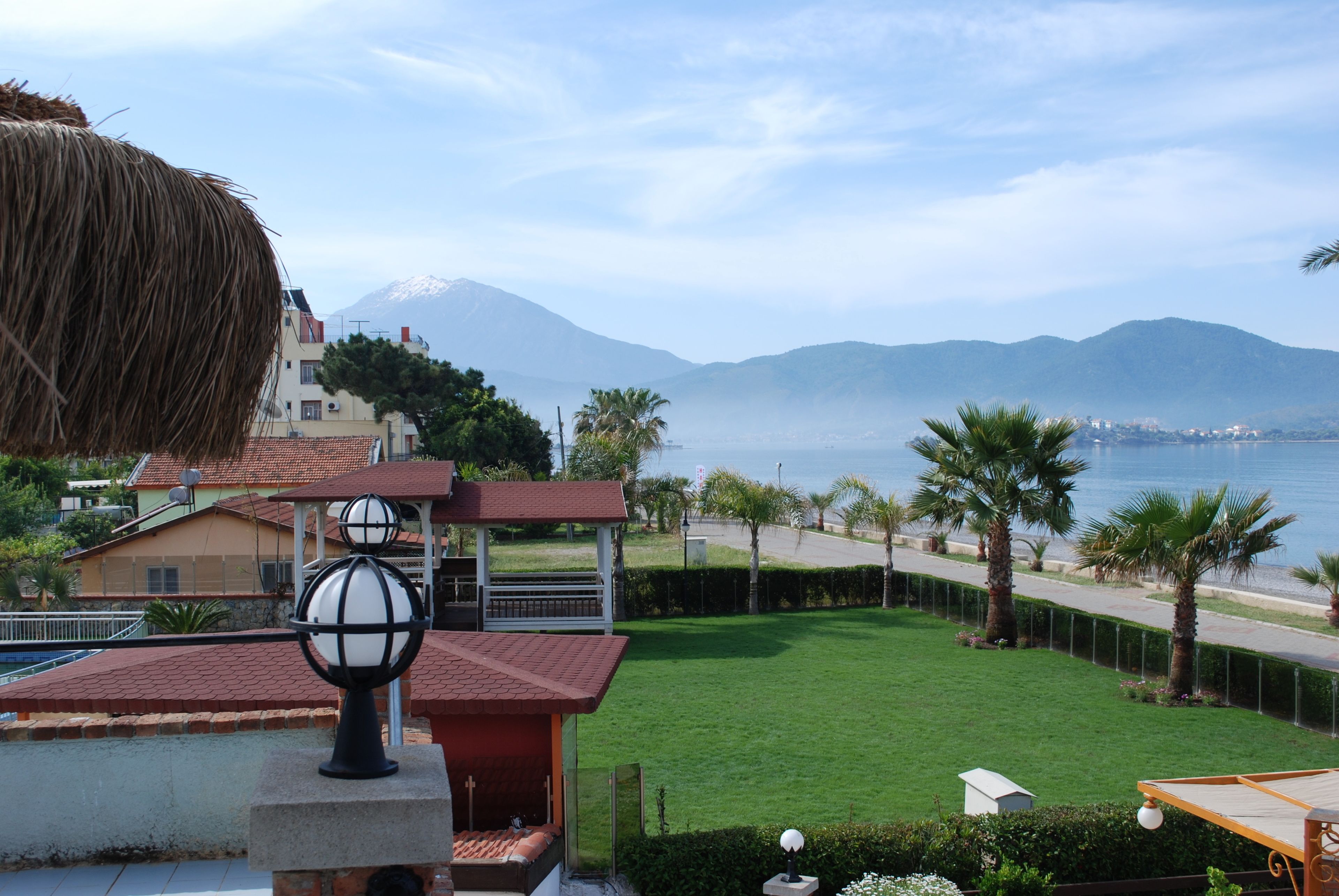A residential area with a view of a mountain and the sea.