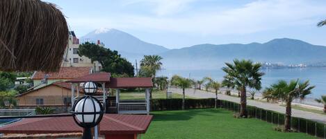 A residential area with a view of a mountain and the sea.