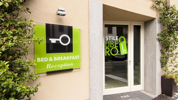 A reception area with a sign for bed and breakfast services.