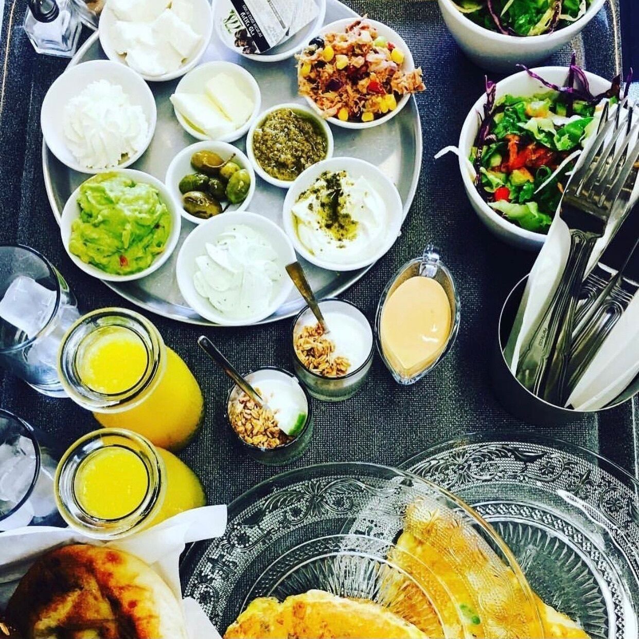A meal with various dishes and drinks on a tray.