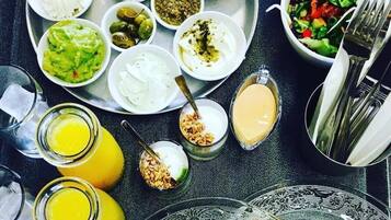 A meal with various dishes and drinks on a tray.