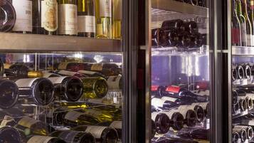 A wine refrigerator stocked with various bottles of wine.