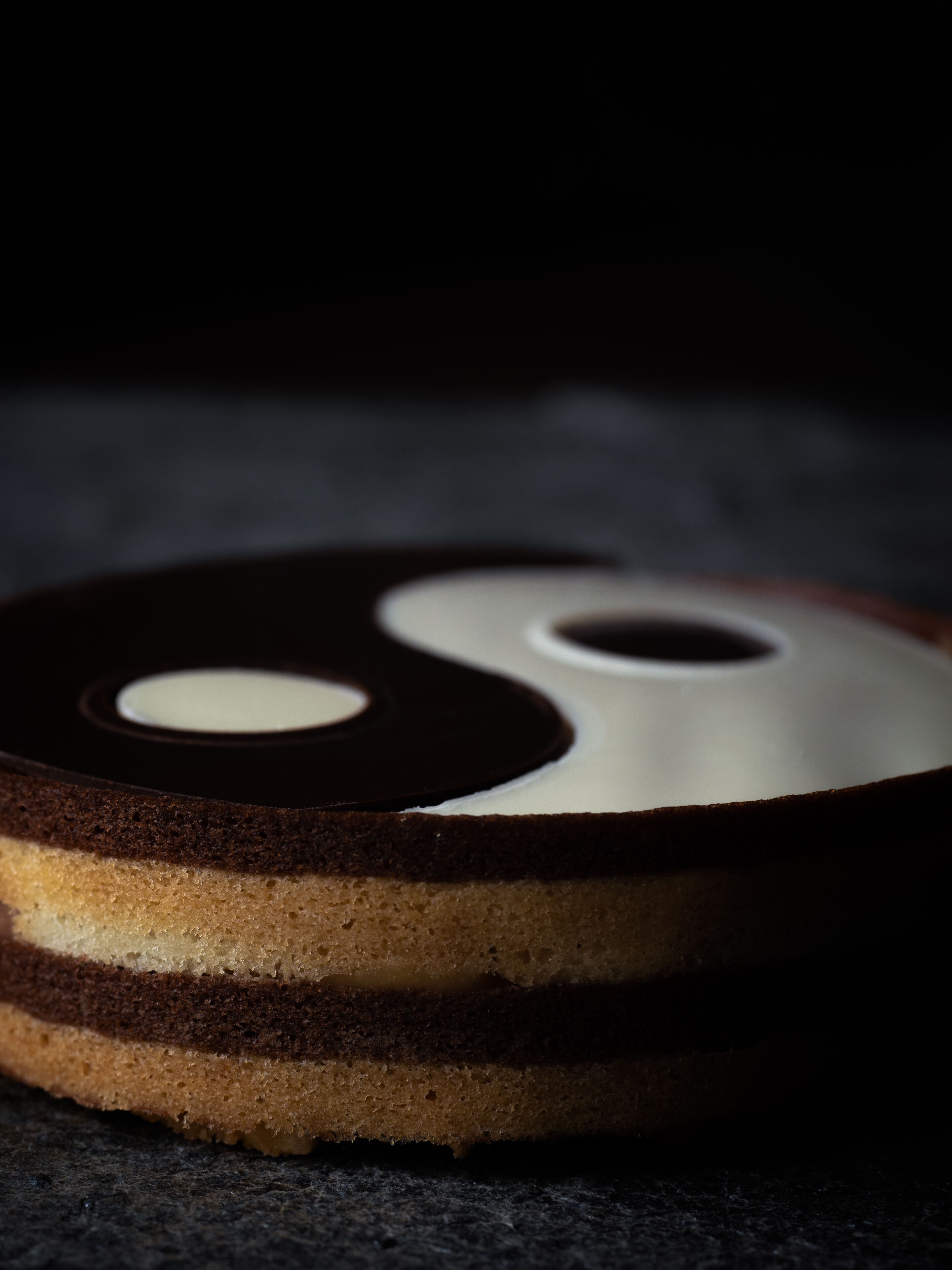 A cake with a yin-yang symbol design on top.