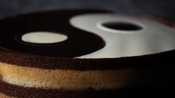 A cake with a yin-yang symbol design on top.