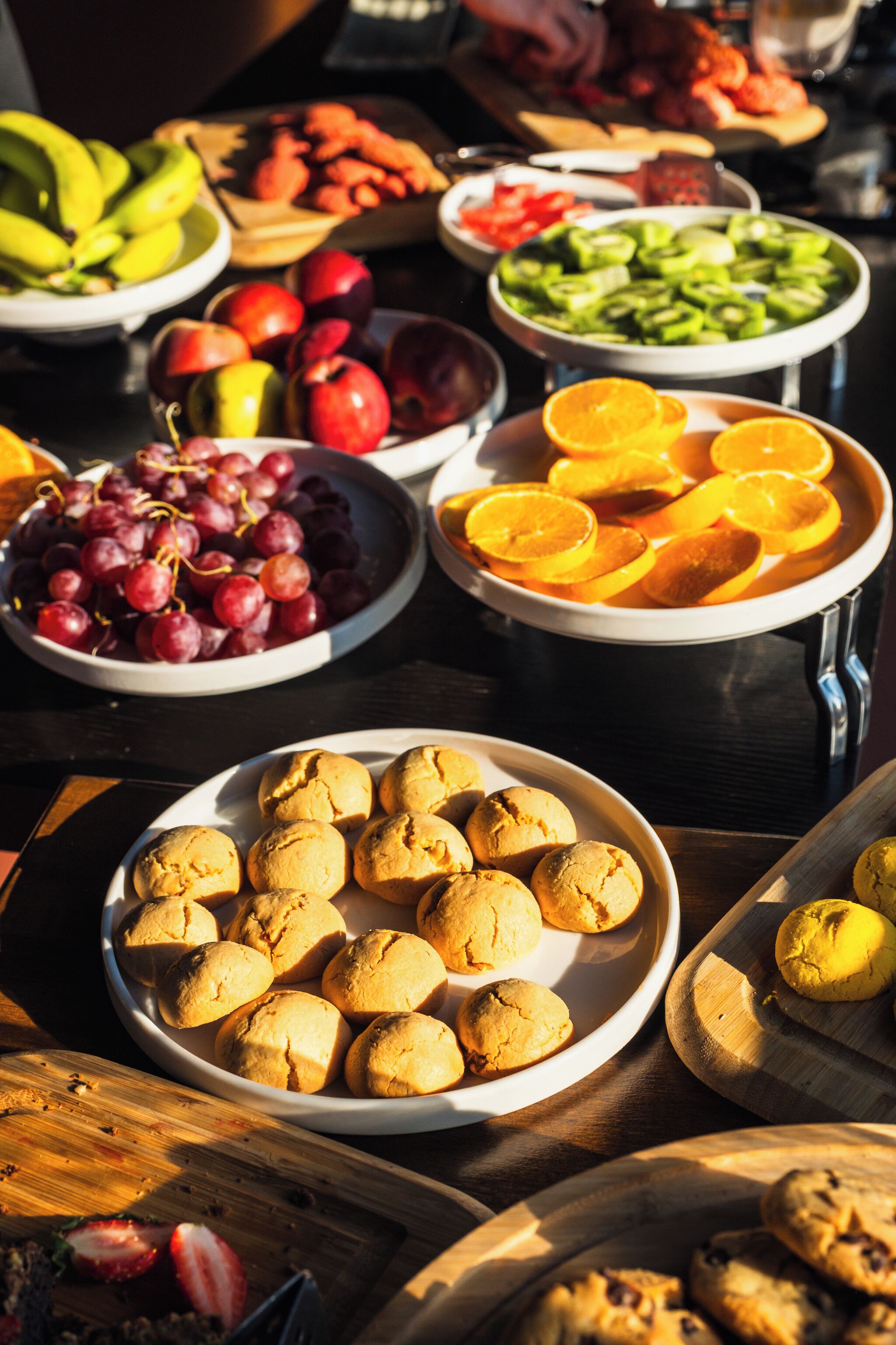 A variety of food items on a table, including fruits, vegetables, and baked goods.