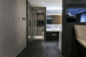A modern bathroom with a glass shower enclosure, a vanity with a mirror, and a toilet. - Saual Keh Hotel (Taipei)