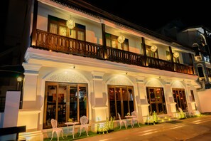 A two-story building with a balcony, large windows, and outdoor seating. - Panna Heritage Boutique Hotel (Chiang Mai)