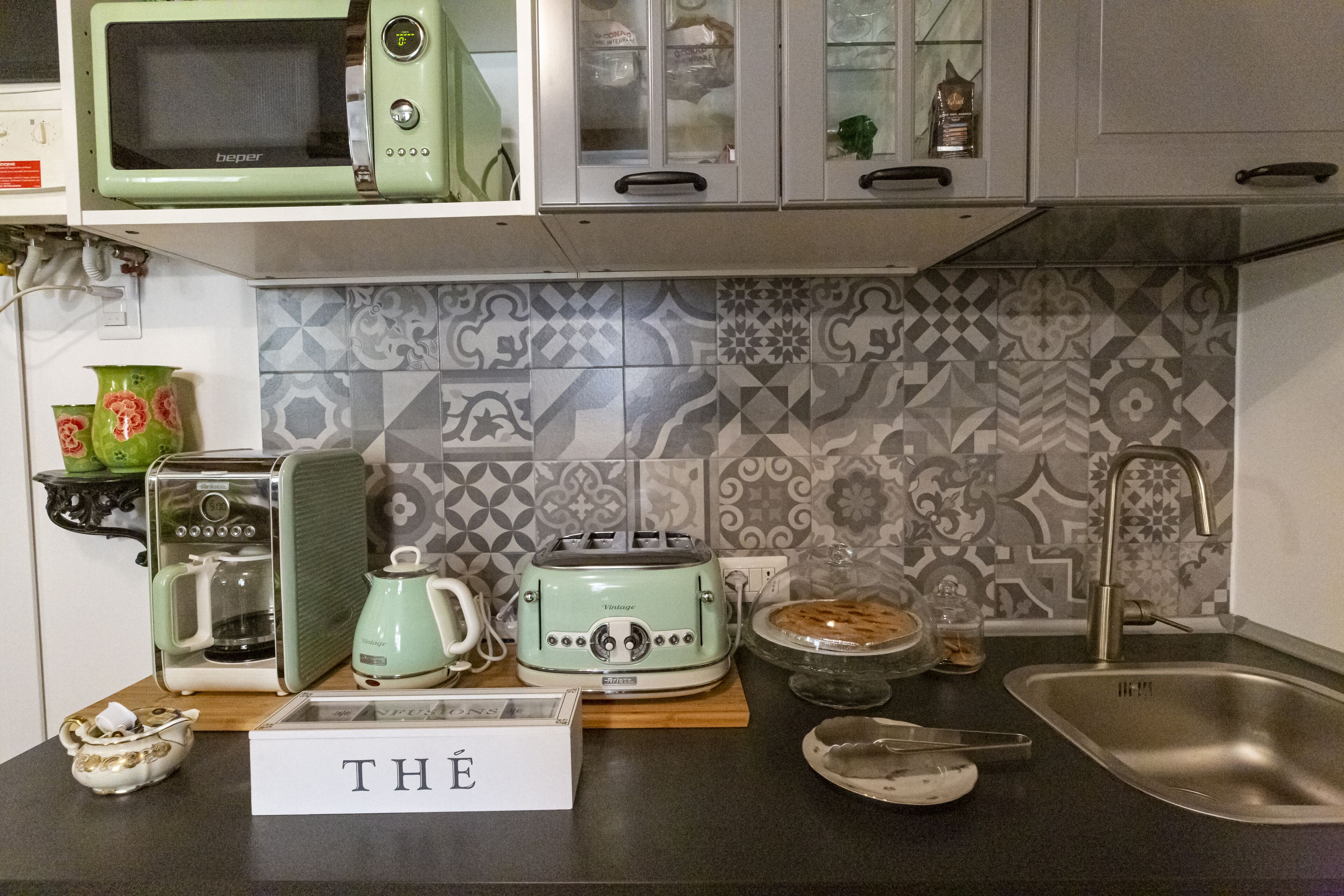 A kitchen with a microwave, toaster, and coffee maker on the counter.