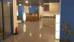 A modern interior with a kitchen area, dining space, and a hallway.