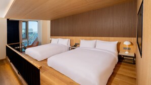 A hotel room with two beds, wooden flooring, a view of a building through a window, and a wooden ceiling. - voco Seoul Gangnam by IHG (Seoul)