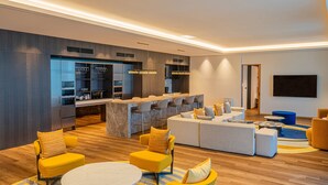 A modern living room with a sofa set, yellow armchairs, and a round coffee table. - voco Seoul Gangnam by IHG (Seoul)