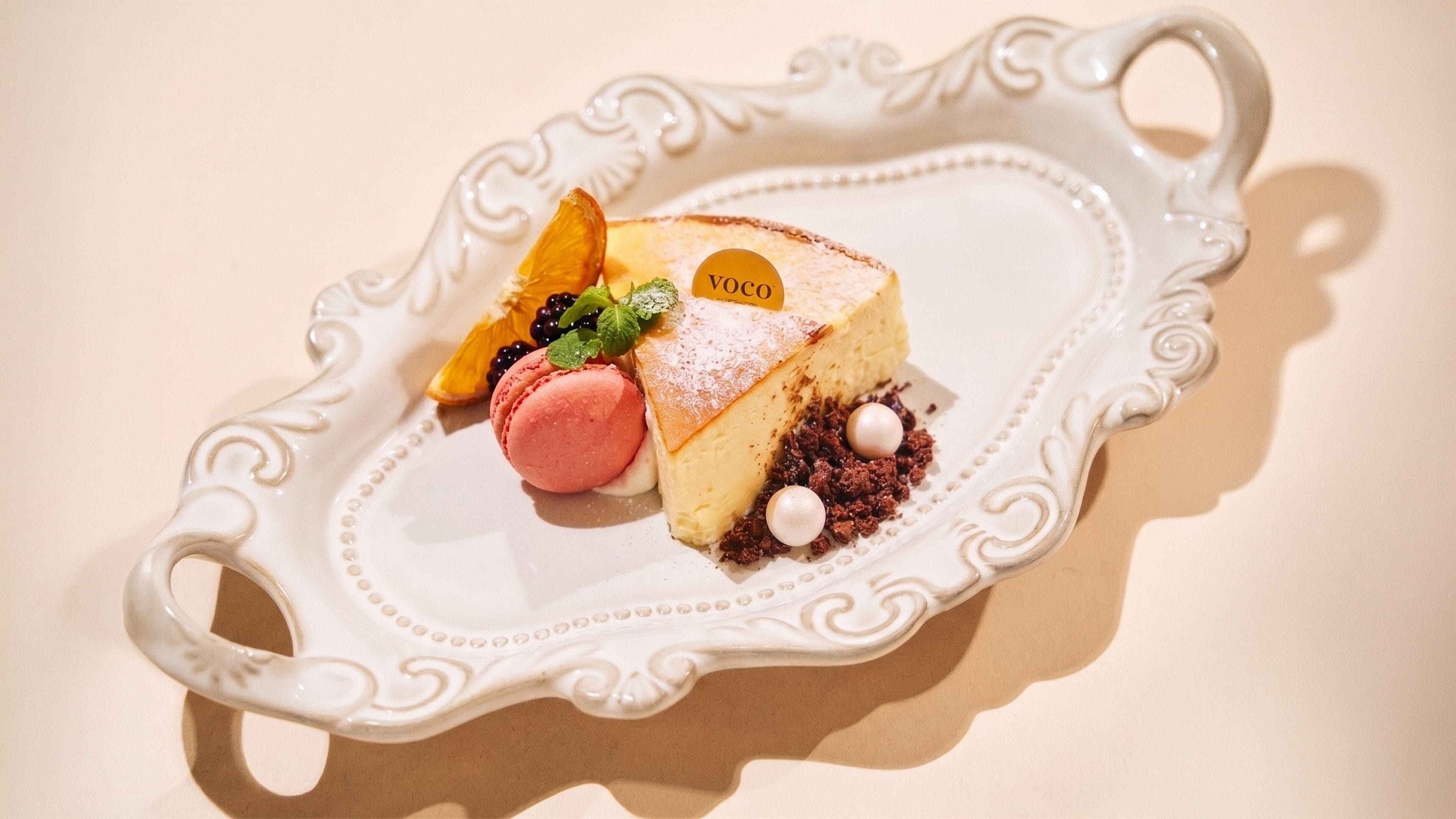 A dessert on a decorative plate with a label.