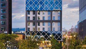 A modern building with a geometric facade and the name "Voco" on the top. - voco Seoul Gangnam by IHG (Seoul)
