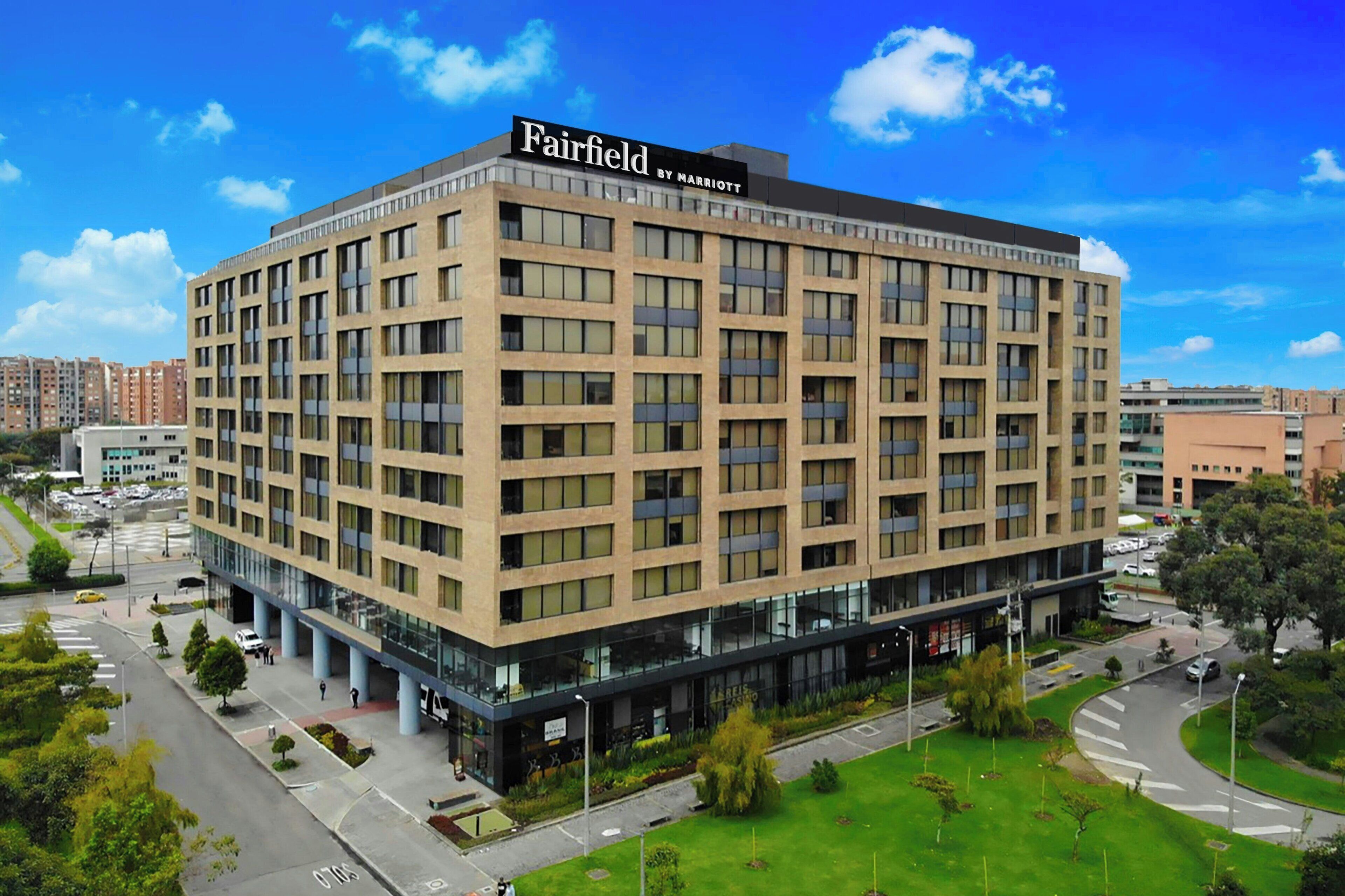 A multi-story hotel with a modern design, featuring a prominent signage at the top.