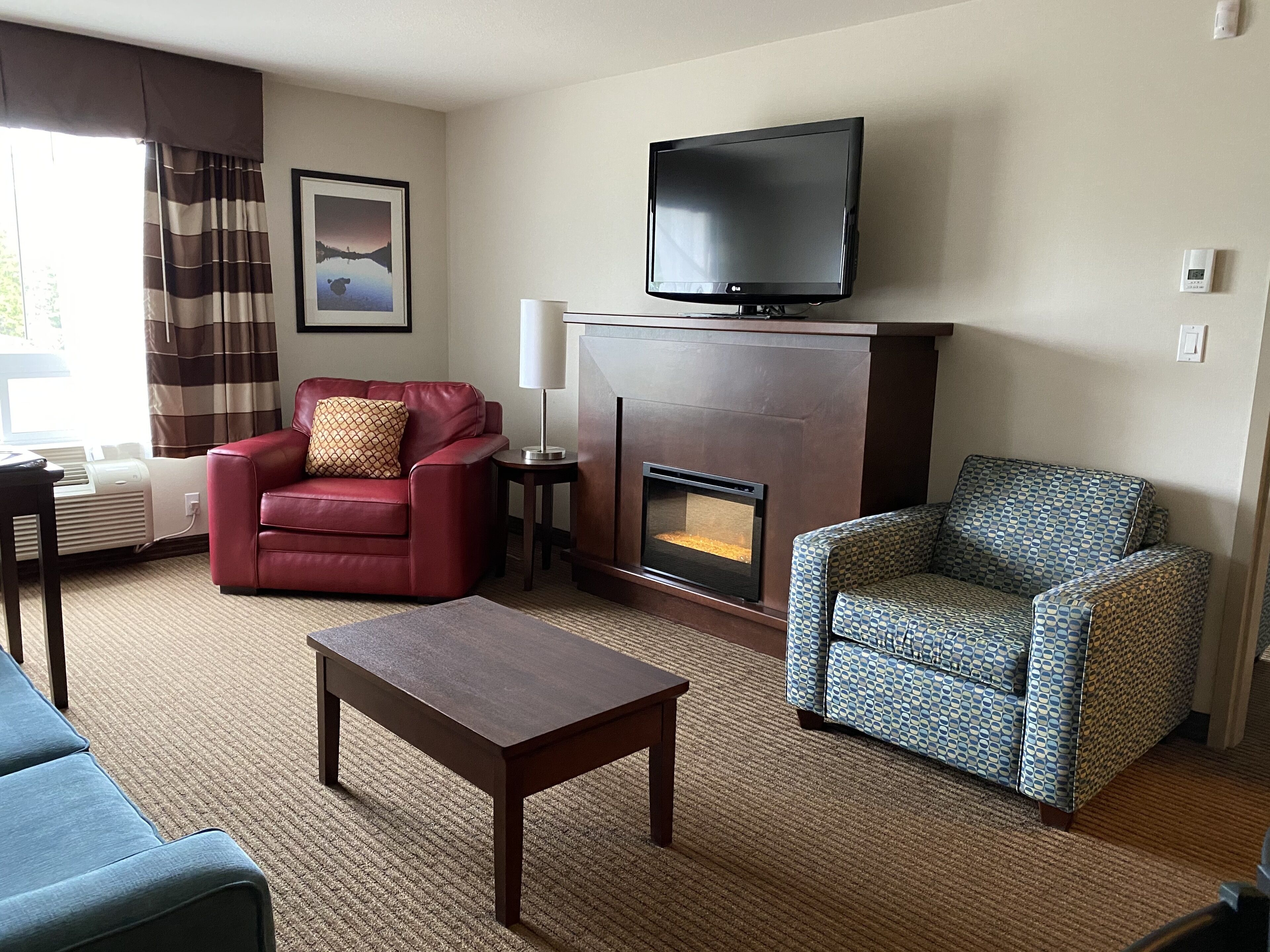 suite, 1 king bed, non smoking, jetted tub | living area | 42-inch flat-screen tv with cable channels, tv