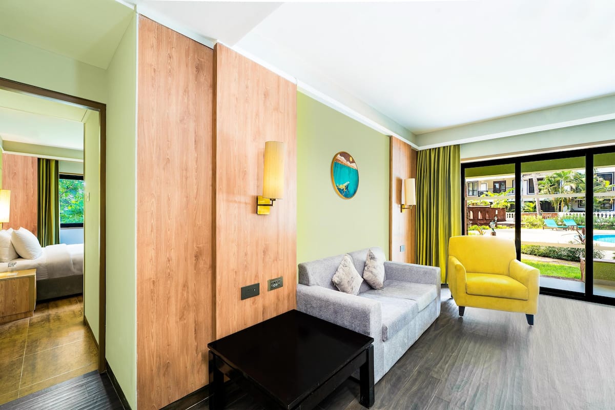 Deluxe Pool View Suite | Living area | LED TV