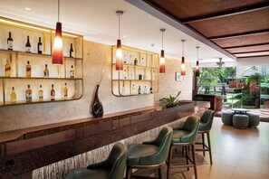 Enjoy a refreshing drink at the hotel bar, where a long counter and comfortable stools invite you to unwind.