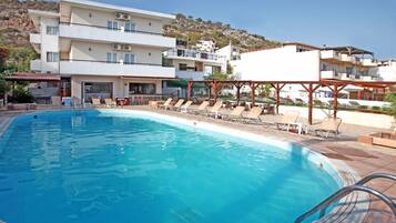 Seasonal outdoor pool, open 9:00 AM to 7:00 PM, pool umbrellas