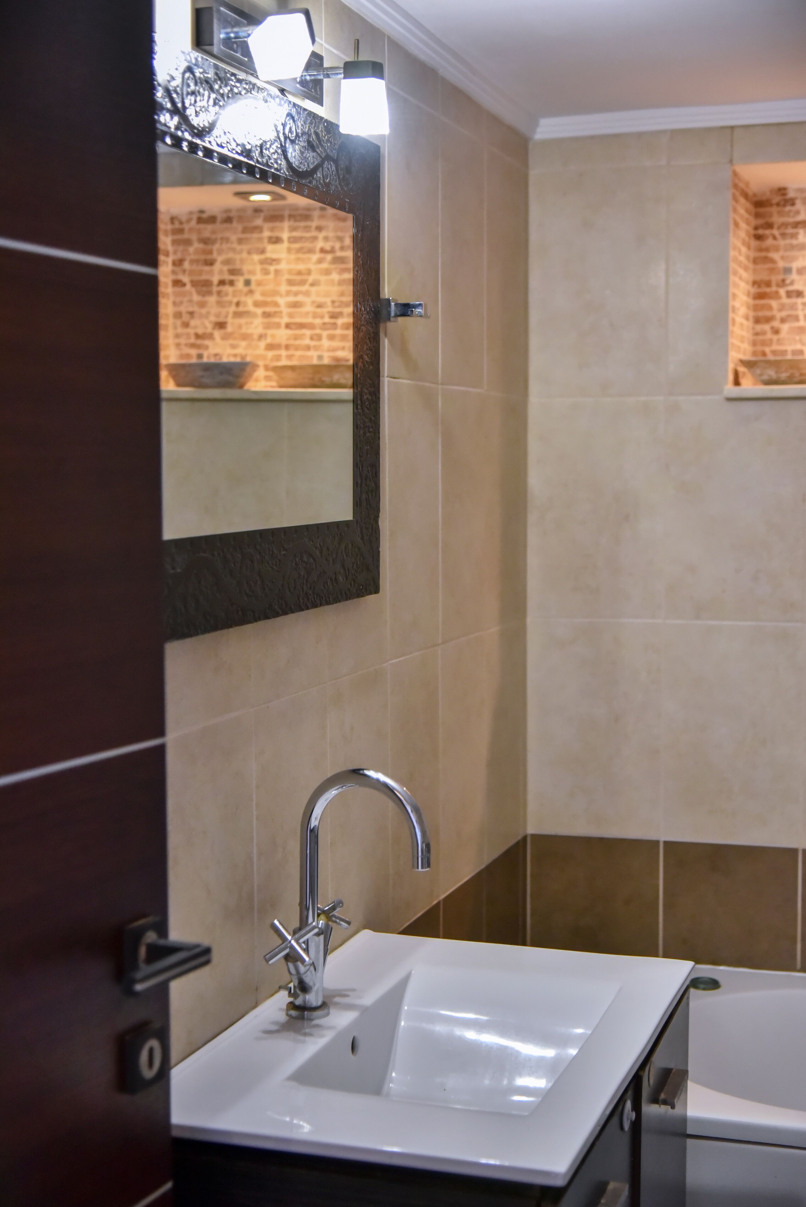 A bathroom with a white sink, a mirror, and a bathtub.