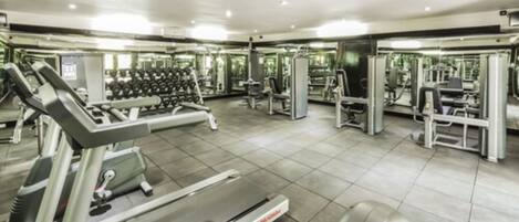 A gym with various exercise equipment, including treadmills and weight machines.