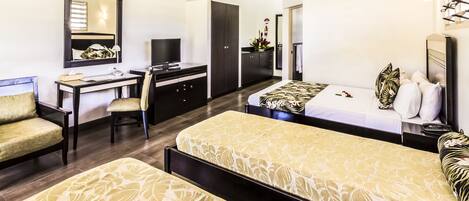A hotel room with a bed, a desk, a chair, a wardrobe, and a bathroom.
