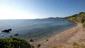 A clear view of a beach with rocky shoreline and calm sea. - Aurora Beach Hotel (Corfu)