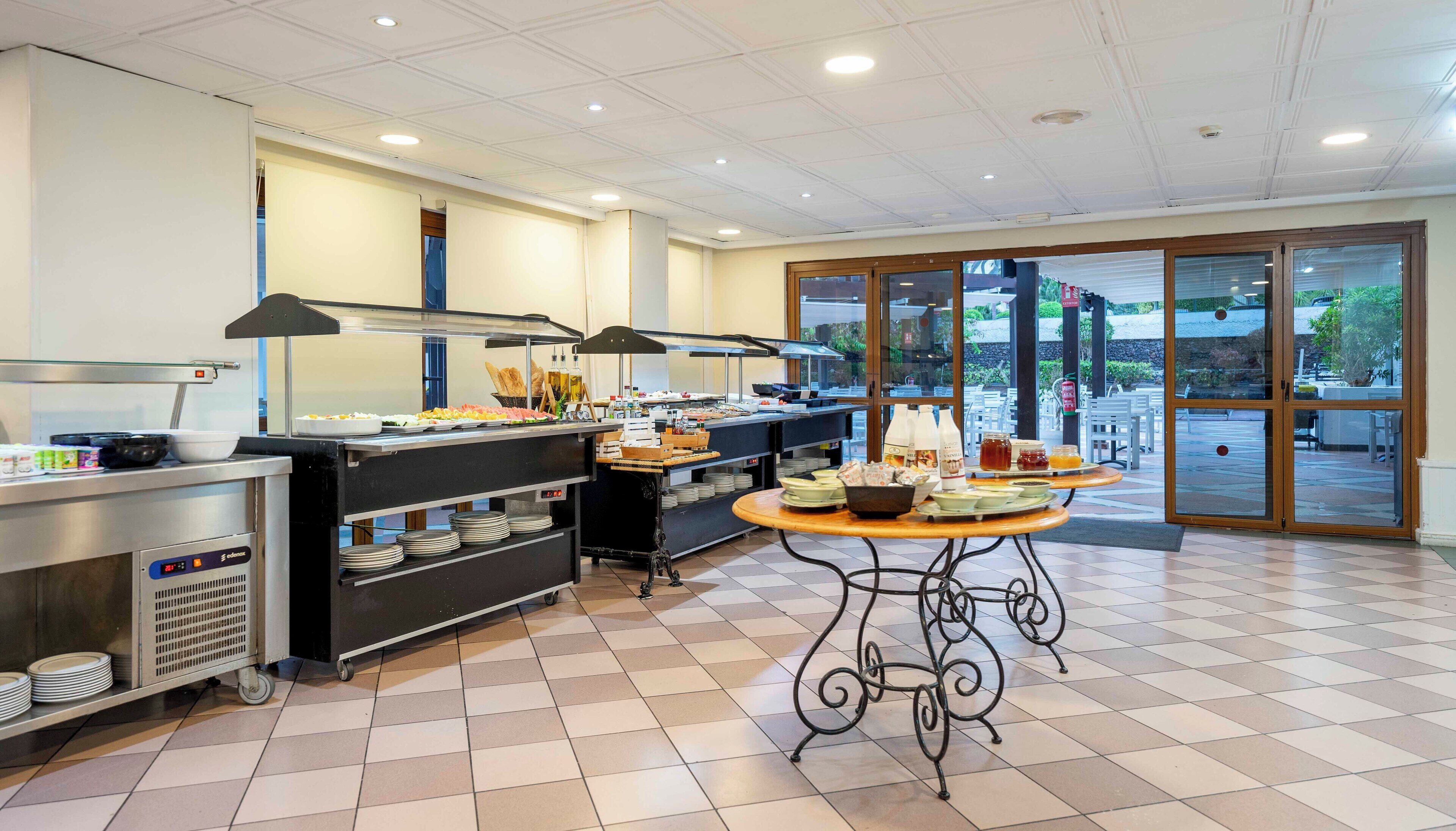 A clean, well-lit buffet area with a variety of food items and a large window providing a view of the outdoors.