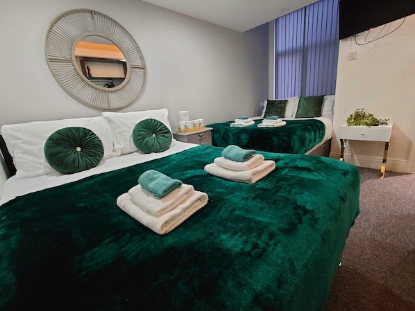 Habitación cuádruple estándar, 2 camas matrimoniales | Escritorio, tabla de planchar con plancha y wifi gratis