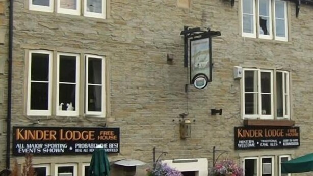 A stone building with two signs advertising 'Kinder Lodge' as a free house. - The Kinder Lodge (High Peak)