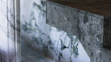 A marble-tiled wall with a water feature.