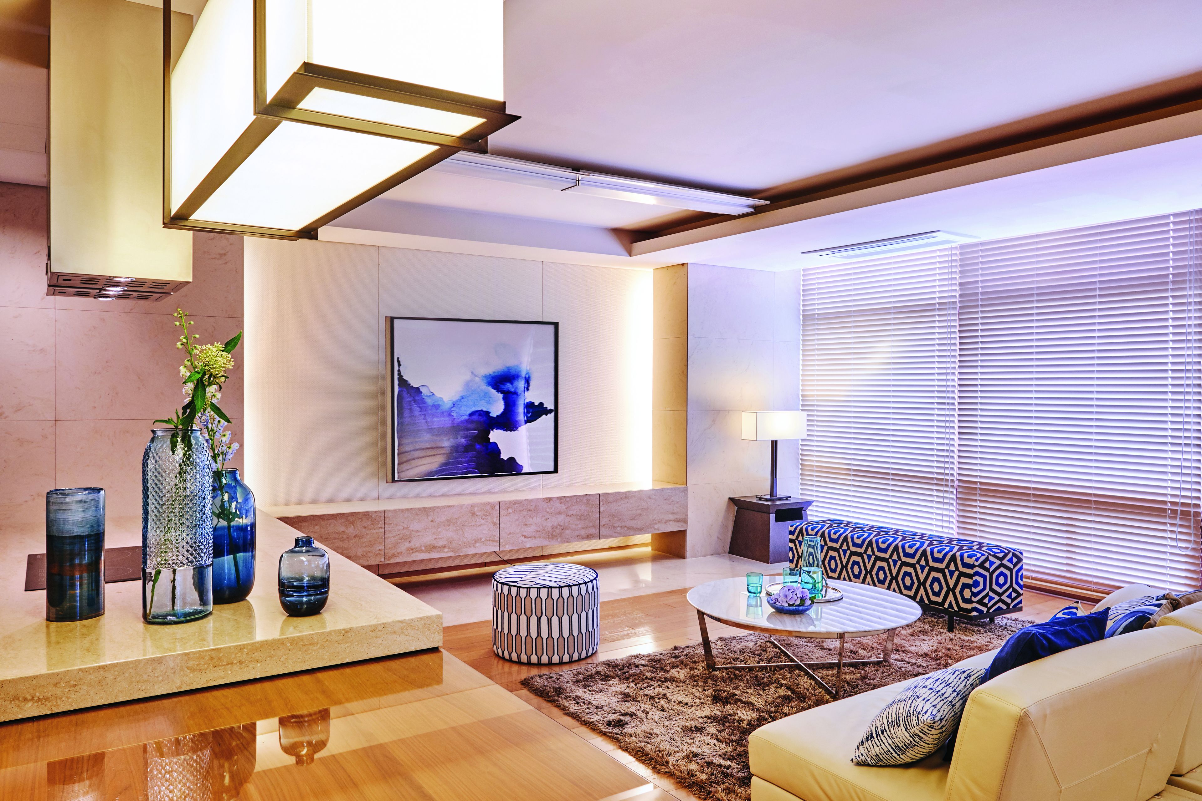 A modern living room with a sofa, coffee table, and decorative vases.