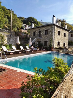 Seasonal outdoor pool, open 10:30 AM to 9:30 PM, pool umbrellas