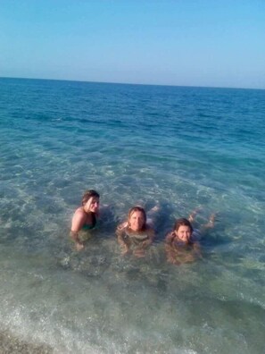 Three individuals in clear water at a beach. - Miression Pelion House (Zagora-Mouresi)