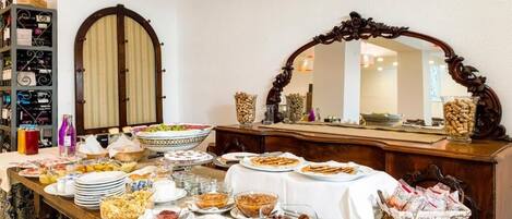 A buffet table with various food items and a wine rack in the background.