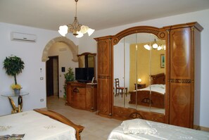 Quadruple Room | Minibar, in-room safe, individually decorated, blackout curtains
