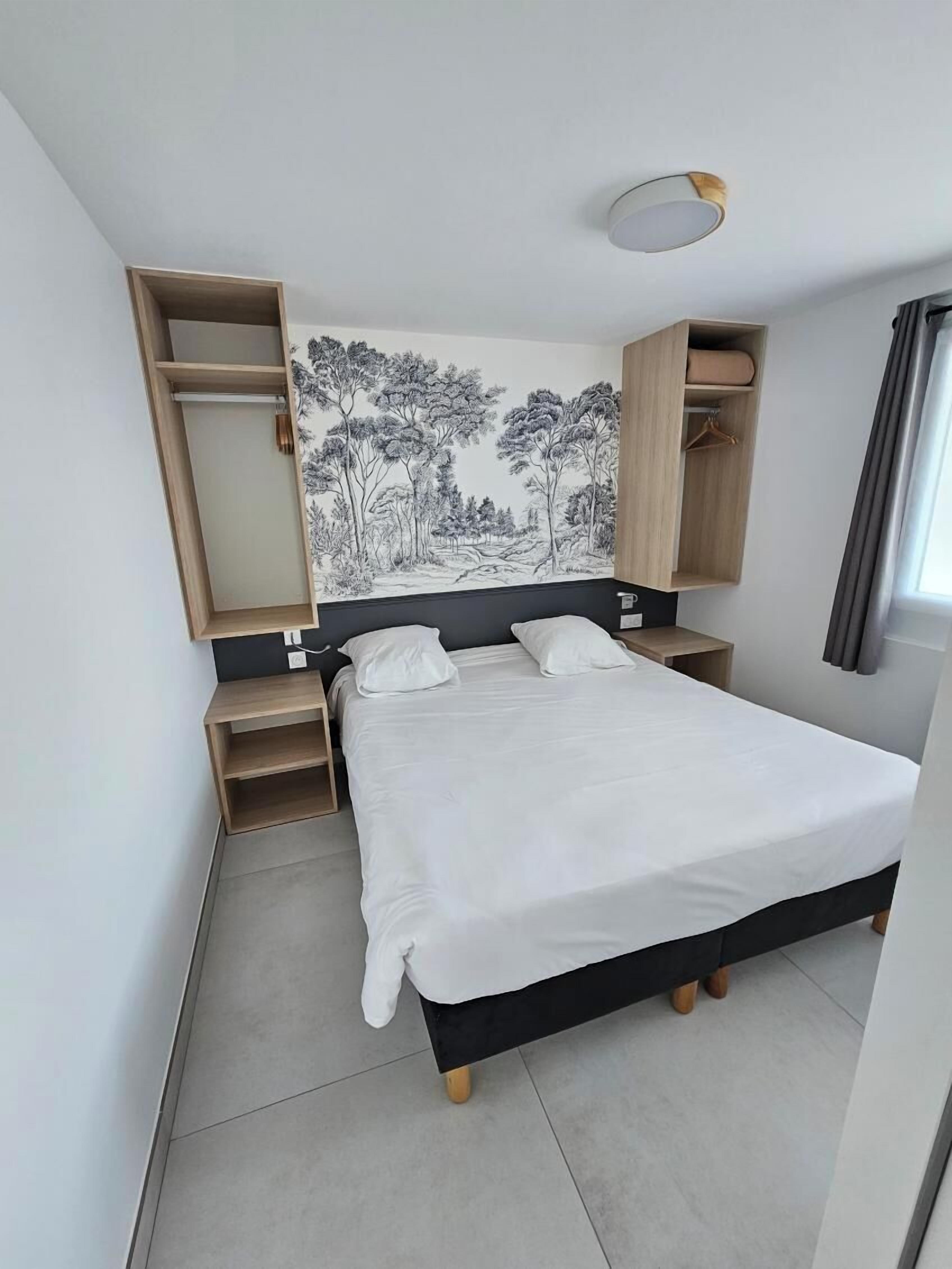 A modern bedroom with a large bed, built-in shelving, and a wall-mounted wardrobe.