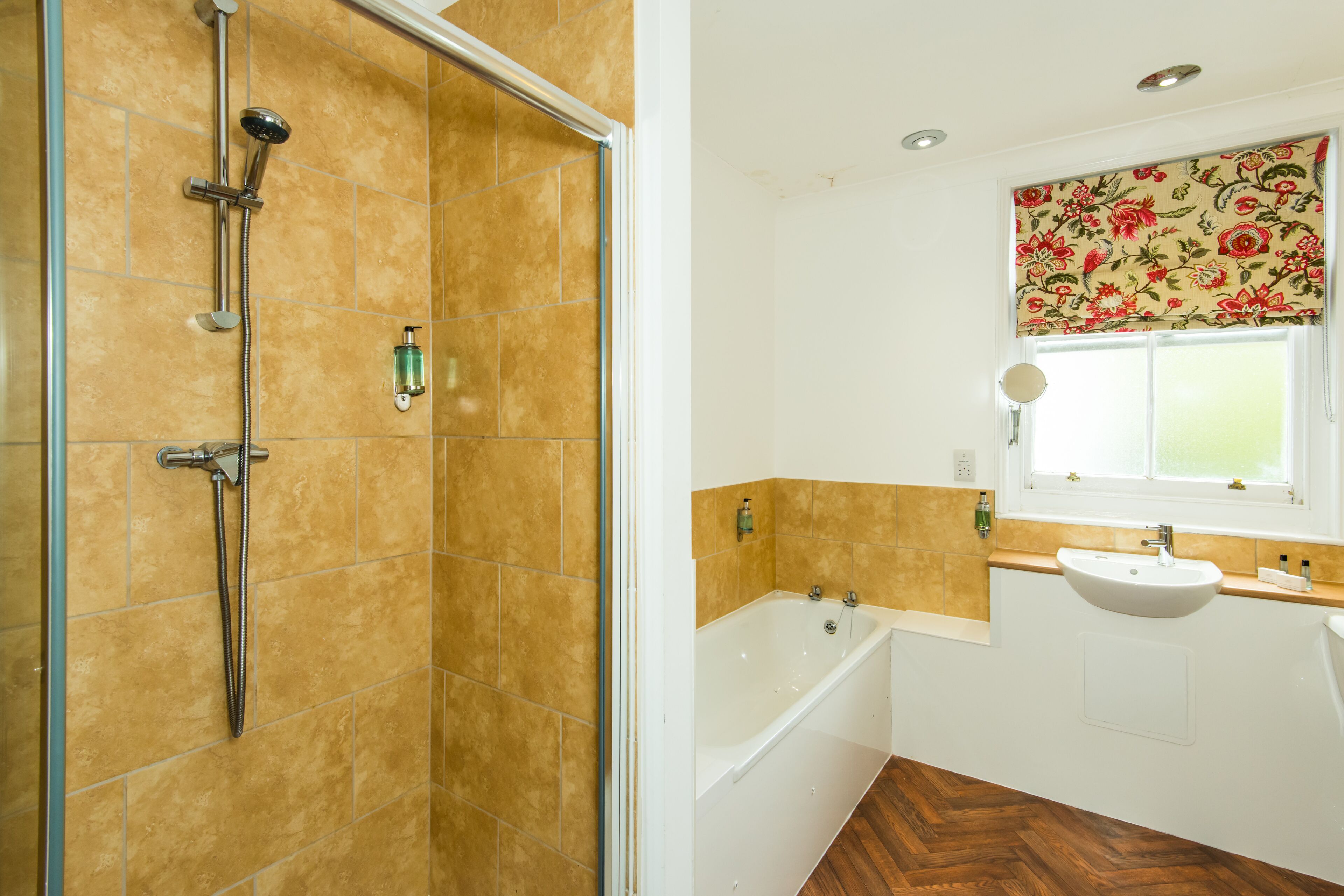 A bathroom with a shower, bathtub, and sink.