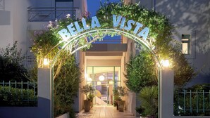 A hotel entrance with a sign reading 'RELLA VISTA' and a pathway leading to the door. - Bella Vista Hotel by Checkin (Hersonissos)