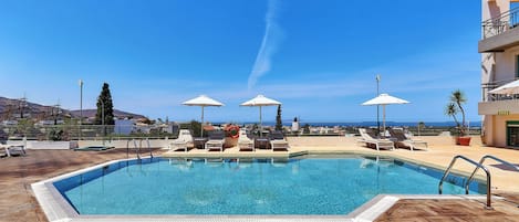 Seasonal outdoor pool, pool umbrellas, pool loungers