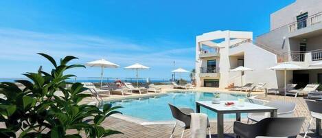 Seasonal outdoor pool, pool umbrellas, pool loungers